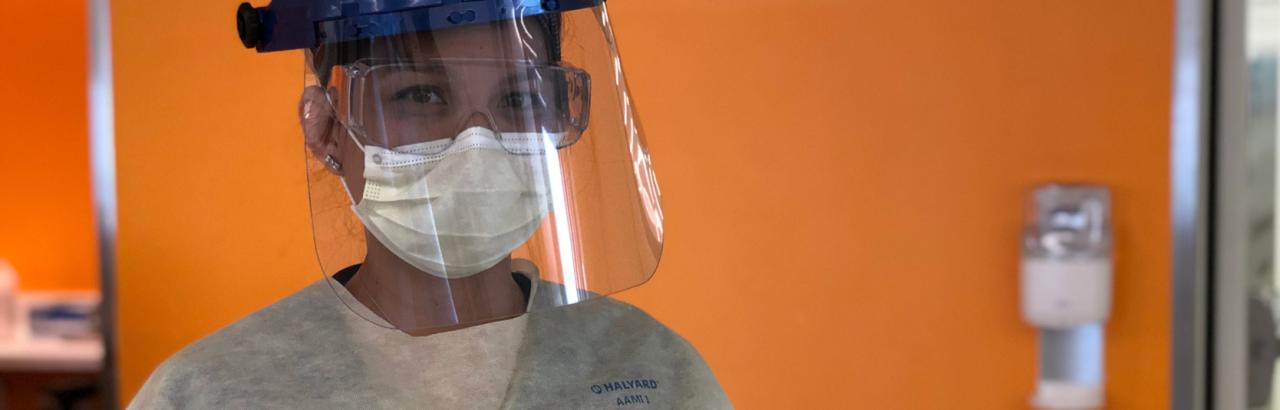 A nurse wears full PPE on the COVID recovery unit